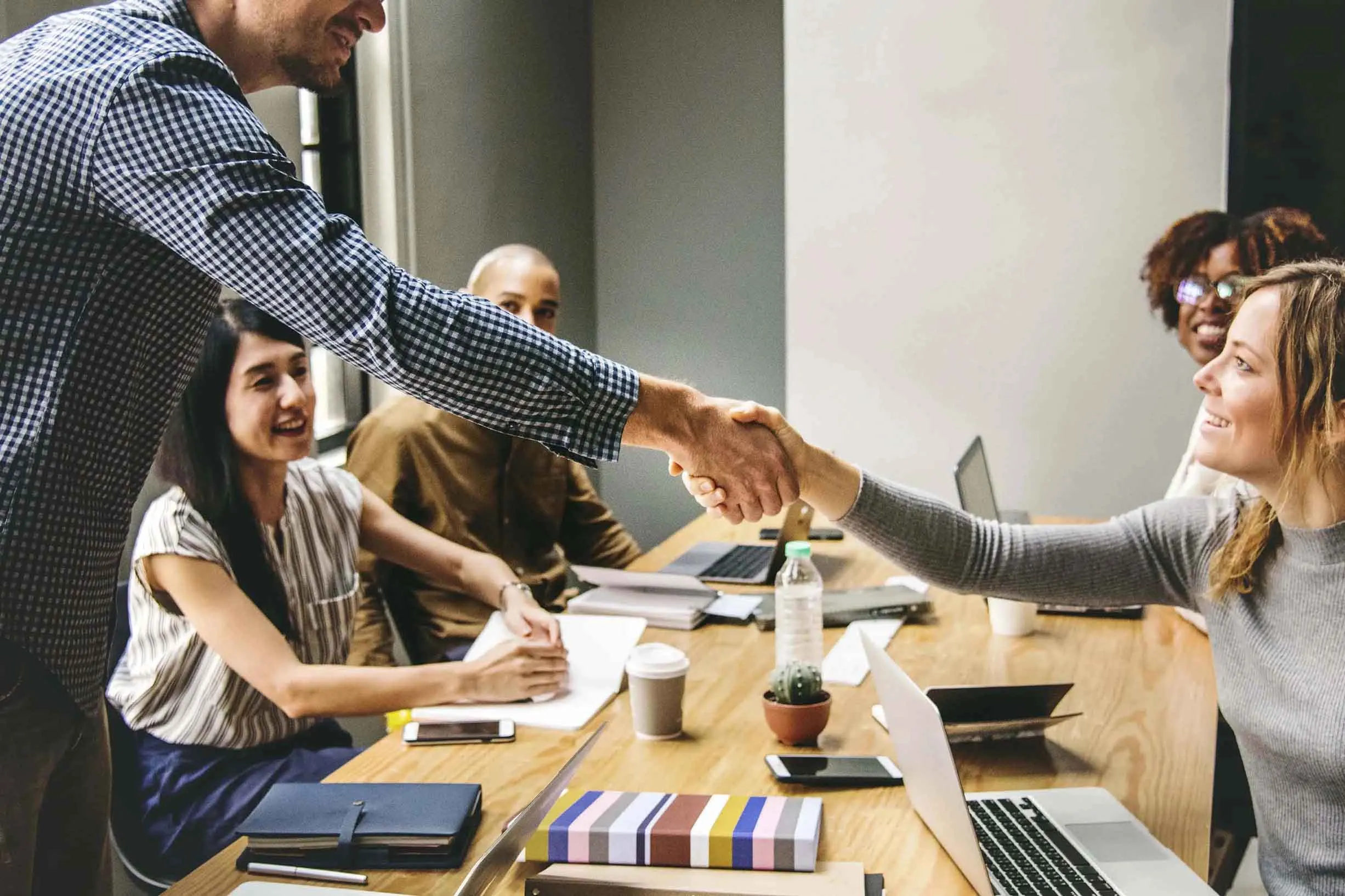 business-people-shaking-hands-agreement.webp